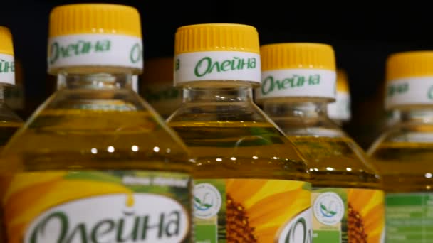 Garrafas plásticas com óleo vegetal de girassol marca Oleina em prateleiras na loja — Vídeo de Stock