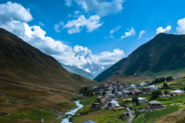 Vesnice Ushguli krajina s masivní rocky mountains — Stock fotografie