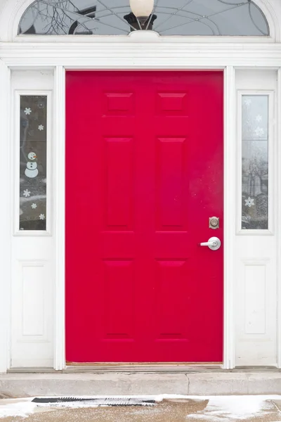 Bright pink door on a white brick building