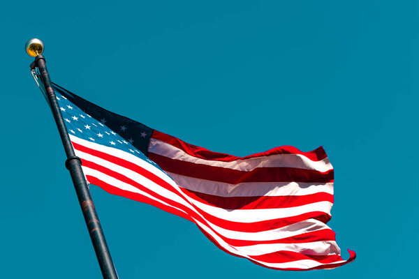 American flag waving on a clear blue sky