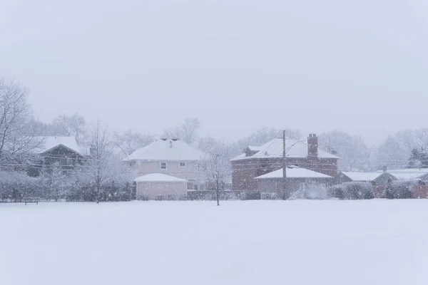 Suburban school field in a park under a heavy winter snow