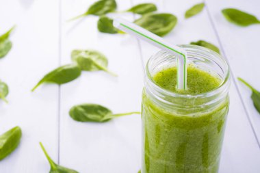 Sağlıklı yeşil kokteyl, ıspanak ve brokoli Beyaz ahşap zemin üzerinde bir cam bardak ile smoothies