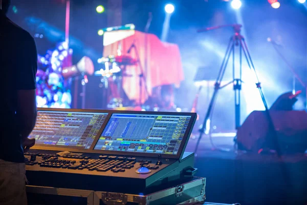 Sound engineer team working to prepare for music concert stage. Hand adjusting audio mixer. DJ for work at a concert in front of the stages