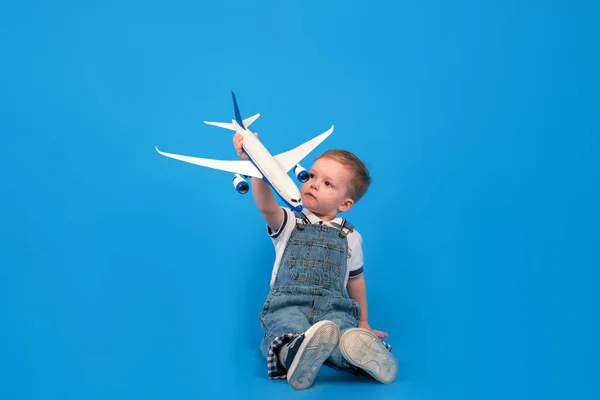 Happy Child Sits Holding Plane His Hand Imagining How Flying — Stock Photo, Image