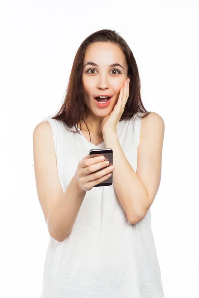 Surprised woman using a smartphone — Stock Photo, Image