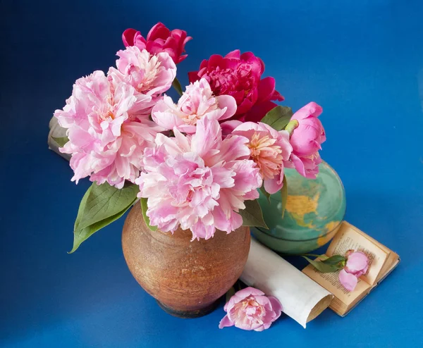 World Teacher\'s Day (still life with peony flowers bunch, books, map and globe on artistic background)