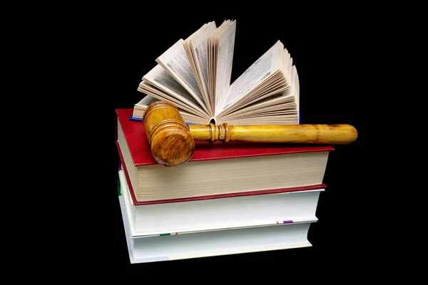 Stack of books and a hammer judge on a black background — Stock Photo, Image