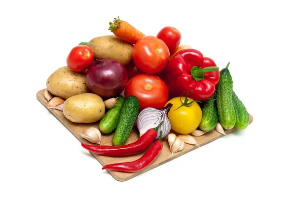 Vegetables on a cutting board on white background — Stock Photo, Image