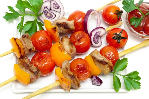 Skewers of meat with vegetables and herbs  on a white background — Stock Photo, Image