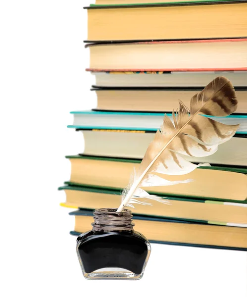 Ink, pen and stack of books on a white background — Stock Photo, Image