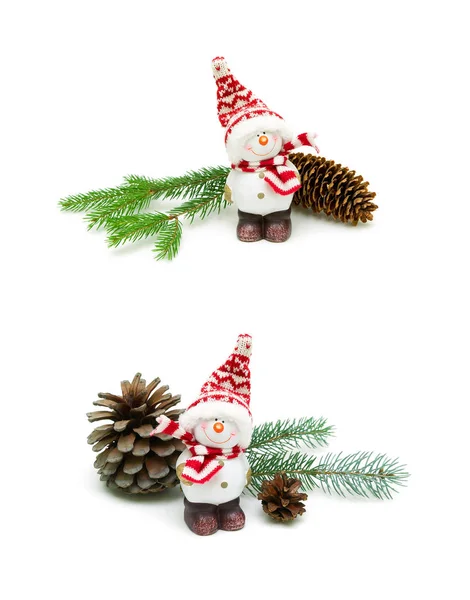 Toy snowman and fir cone on a branch on white background Royalty Free Stock Photos