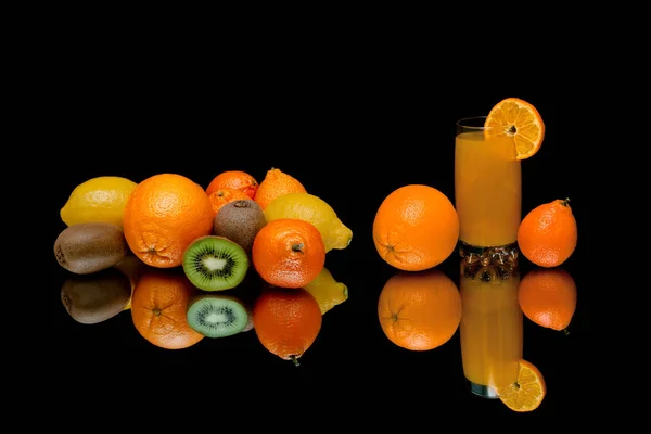 Ripe fruits and drink on a black background — Stock Photo, Image