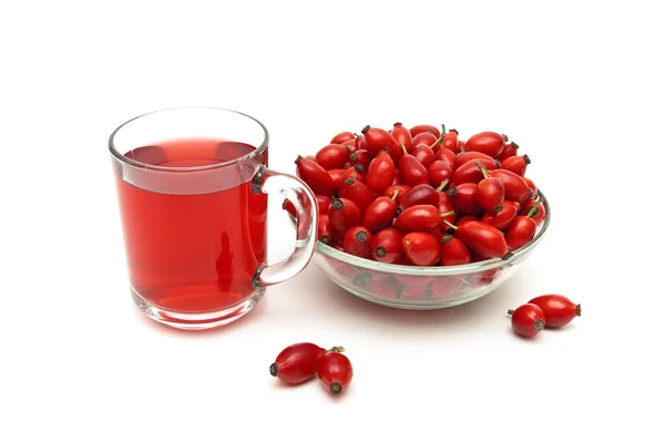 Rose hips and a drink on a white background — Stock Photo, Image