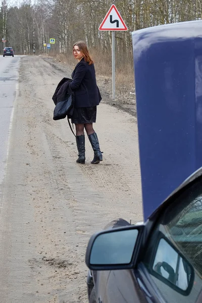 Молодая девушка голосует на дороге — стоковое фото
