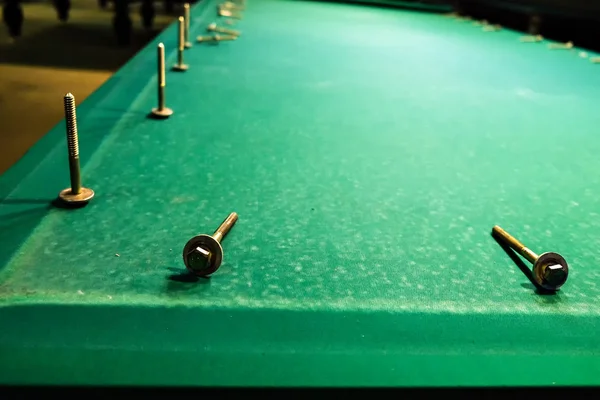 The bolts are on the felt pool table — Stock Photo, Image