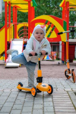 bir scooter üzerinde küçük kız