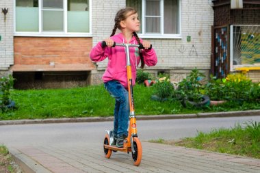 bir scooter üzerinde küçük kız