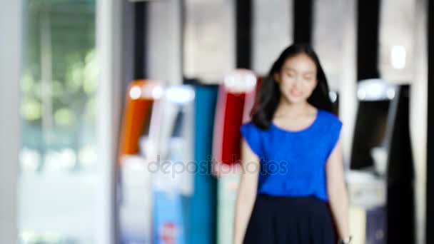 Girl holding credit card in front of the bank — Stock Video