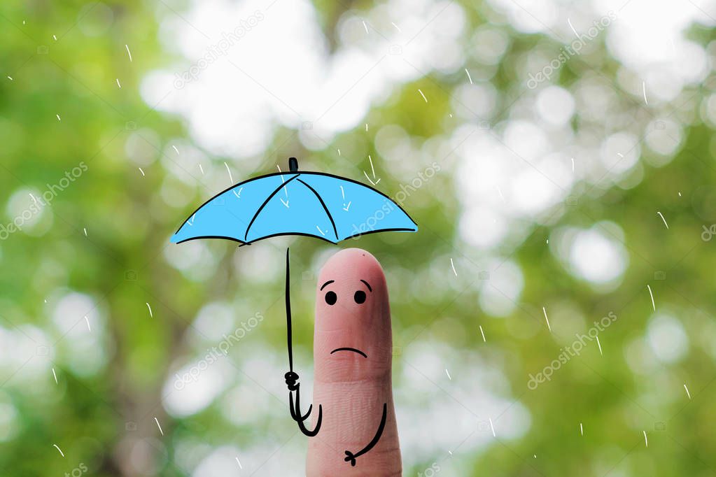 Finger art .Cute little boy holding an umbrella and dancing in rains on nature background for Monsoon Season.