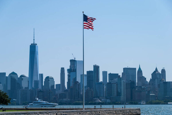 American flag with New York downtown in the background