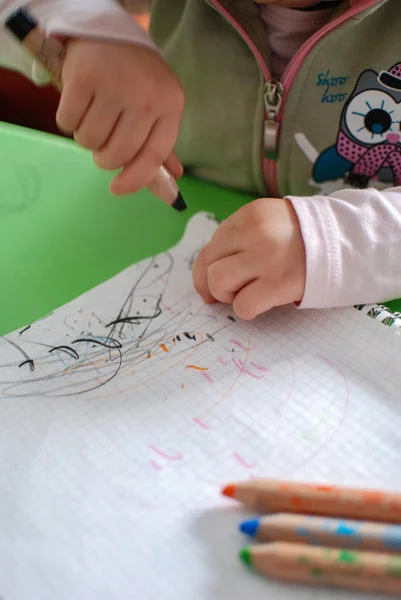 Child drawing with crayons Royalty Free Stock Photos