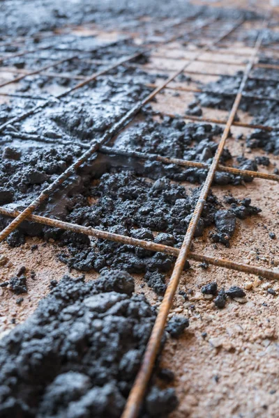 Steel reinforcement mesh on gravel floor with concrete — Stock Photo, Image