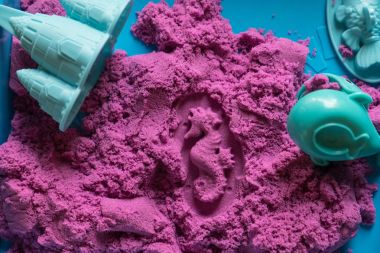 Sea horse shape stamped into the kinetic sand  clipart