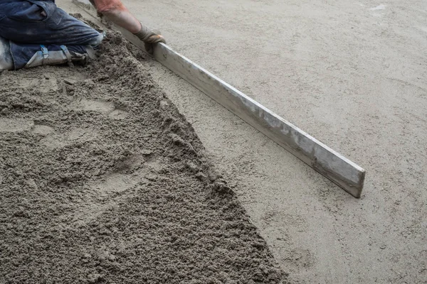 Worker flattening the cement floor — Stock Photo, Image