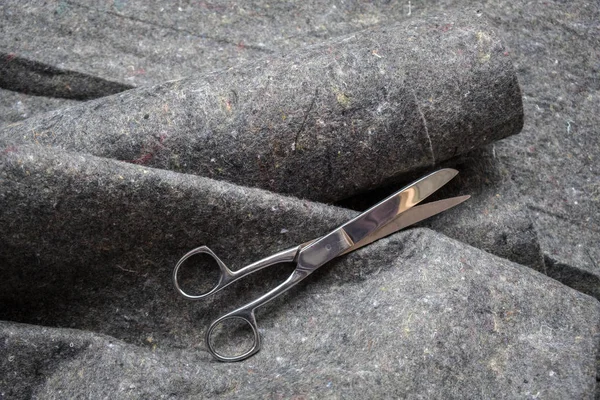Grey geo textile fabric rolls with scissors — Stock Photo, Image