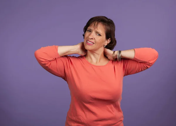 Middle Aged woman with neck and shoulder pain holding her neck — Stock Photo, Image