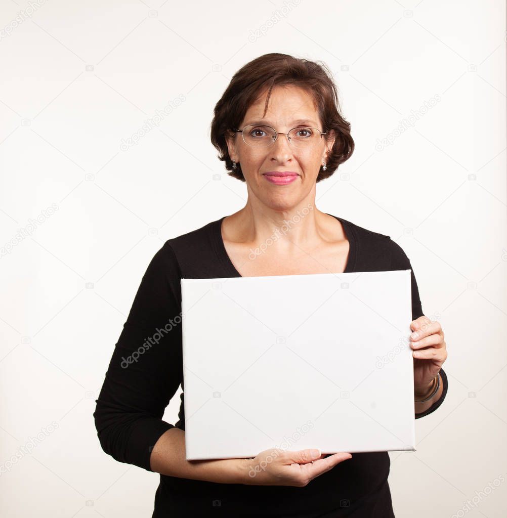 Woman holding up a blank white sign with room for your copy