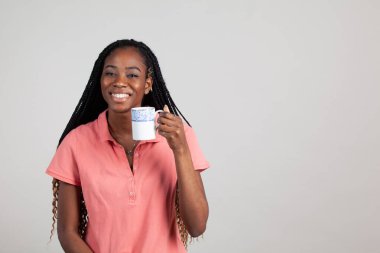 African American Woman holding a cup of Tea.