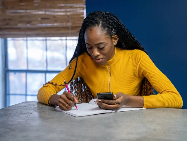 Young African American woman with yellow shirt sitting — Stock Photo, Image