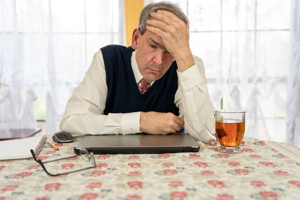 Cansado homem trabalhando no computador na sala de jantar — Fotografia de Stock