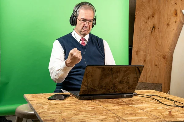 Man working from home in his basement on a virutal meeting. — Stock Photo, Image