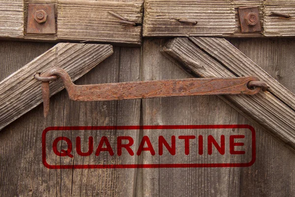 The gates are closed for quarantine. Wooden gate with metal rust hook. stay at home.