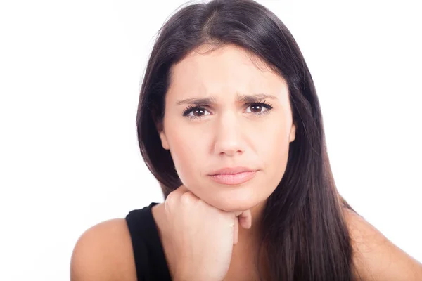 Upset woman with hand on chin — Stock Photo, Image