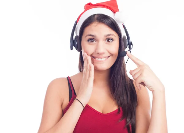 Donna sorridente con auricolare in cappello di Babbo Natale — Foto Stock