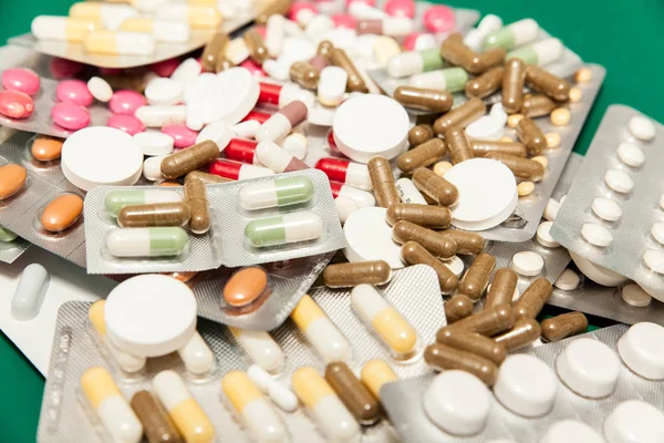 colourful medicines on green table