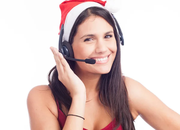 Smiling woman in Santa hat and headset — Stock Photo, Image