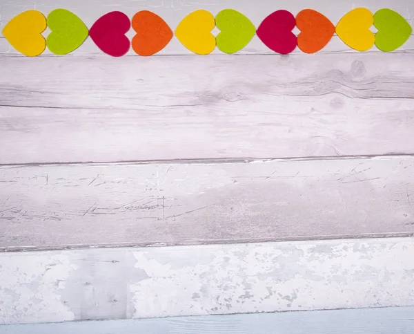 Colorful felt hearts on a background of old wooden planks resemb — 스톡 사진