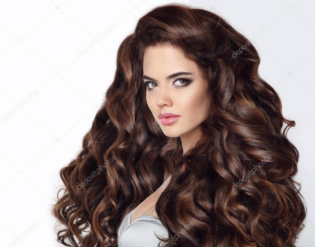 Long hair. Beautiful brunette woman portrait with curly shiny ha