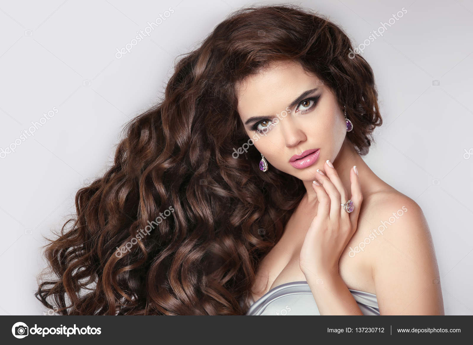 Curly hair. Beautiful brunette woman model with makeup, fashion Stock Photo  by ©VictoriaAndrea 137230712