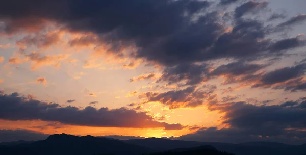 Ηλιοβασίλεμα. Σύννεφα φόντο του ουρανού. Ridge βουνό σιλουέτα. Skyli — Φωτογραφία Αρχείου