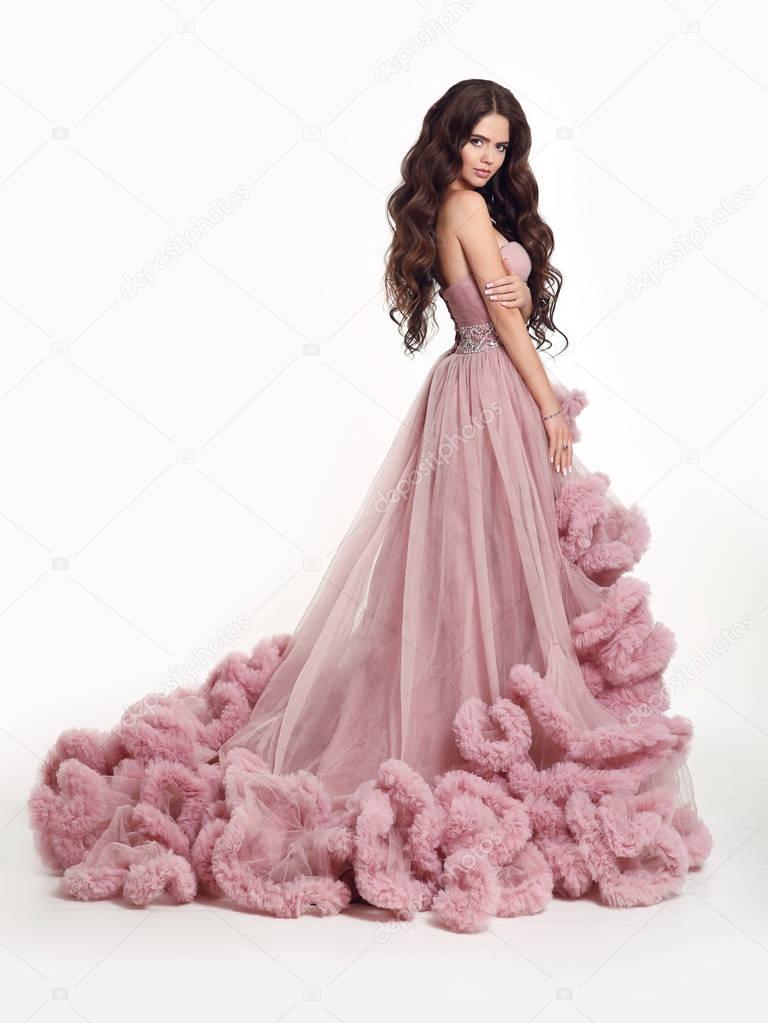Beautiful Lady in luxury lush pink dress. Fashion brunette woman