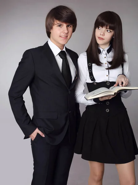 Happy teenagers in school uniform portrait. Handsome boy and bea — Stock Photo, Image