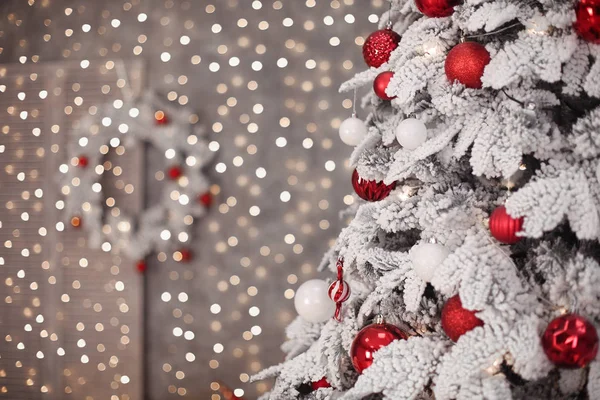 Snöiga julgran med röd gåvor dekoration innan bokeh ligh — Stockfoto