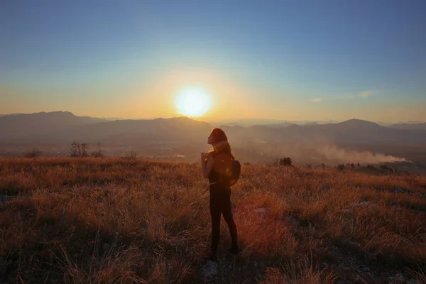 Sunset mountain. Tourist Free happy  woman outstretched arms wit