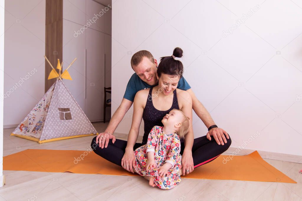 Full young family goes sports at home togetherness. Mom dad baby kid doing yoga exercises. Love harmony idyll. Leisure healthy lifestyle. Activity morning. mental health resilience contented emotion