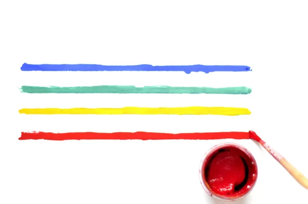 Brush with paint and colored stripes — Stock Photo, Image